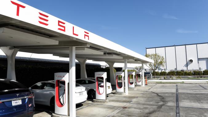 3 vehicles parked at a Tesla Supercharger station at the Tesla Design Center in Hawthorne, California